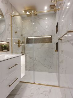 a bathroom with white marble and gold accents