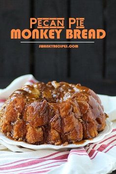 a piece of pecan pie monkey bread on a white plate with red and white striped napkin