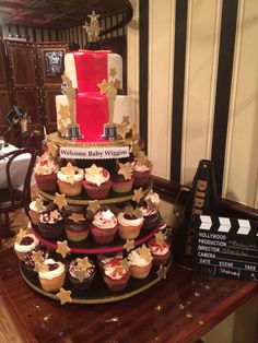 a three tiered cupcake cake with red and white frosting