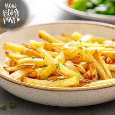 a bowl filled with french fries on top of a table