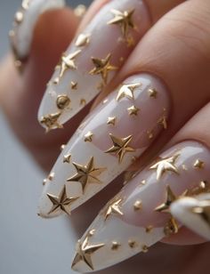 This elegant design features a clear gel base with three-dimensional gold stars scattered across the nails. The stiletto shape adds drama and sophistication, making it perfect for special occasions in February. This look is ideal for those who want a bold yet chic statement in their February nails ideas 2025. Star Nails, Gold Stars, Elegant Design