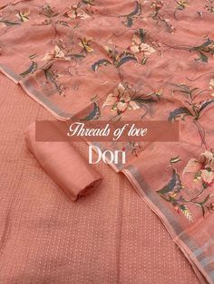 an orange colored sari with flowers on it and the words threads of love don