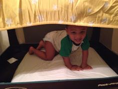 a little boy laying on top of a bed