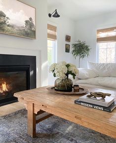 a living room with a couch, coffee table and fire place in front of the fireplace