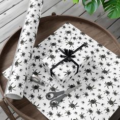 a table topped with white and black spider napkins