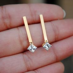 "Simple, elegant and stylish - these pair of earrings are a must have. Their versatility make them a keeper and absolutely to die for..! 0.33 ct Princess cut diamonds, dangling delicately from matt gold bar, worth a second glance! * Diamond Wt. : 0.65 Cts * Color-Clarity Grade : H-I, VVs-Vs * Gold - 14k, 2.45 gms yellow gold If you like this earring, please press \"Pin it\" button on the right of your screen. Find us on Instagram for exquisite designs: @abhikajewels Like us on Facebook: www.face Luxury Single Linear Earring For Anniversary, Elegant Rose Gold Long Drop Earrings, Minimalist Formal Diamond Drop Earrings, Dainty Linear Drop Earrings For Formal Occasions, Luxury Drop Linear Earrings Gift, Luxury Linear Drop Earrings Gift, Modern Wedding Crystal Drop Earrings, Modern Crystal Drop Earrings For Wedding, Anniversary Crystal Long Drop Earrings