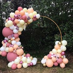 an arch made out of balloons and flowers