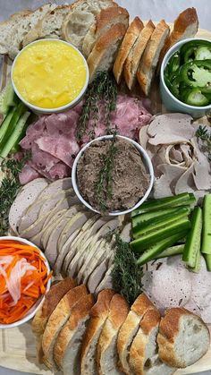 a platter filled with meats, bread and veggies