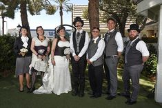 a group of people that are standing in the grass