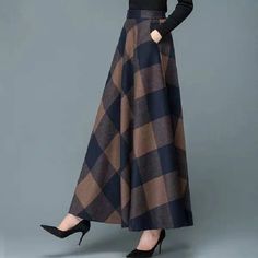 • Premium Woolen Material :Crafted from high-quality woolen fabric, this skirt offers a luxurious feel and superior warmth, perfect for the autumn and winter seasons. • Classic Plaid Design :The skirt features a timeless plaid pattern, adding a touch of retro charm to your wardrobe, suitable for both casual and semi-formal occasions. • Retro Plus Size :Designed with a plus size retro style, this mid-length A-line skirt provides a flattering silhouette, making it an ideal choice for all body types. • High Waist Slim Fit :The high waist design of this skirt accentuates your waistline, creating a slimming effect, while the long length adds a touch of elegance and sophistication. • Swing Skirt Style :The swing skirt style offers a comfortable fit and a flowy movement, making it a perfect choic Long Skirt Winter, Maxi Skirt Winter, Long Plaid Skirt, Winter Maxi, Big Skirts, New Party Dress, Knitted Skirt, Office Dresses For Women, Beautiful Prints