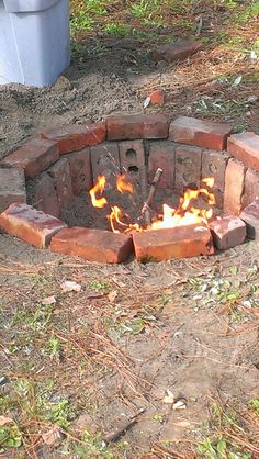 a fire pit made out of bricks in the dirt