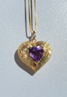 "14 Karat solid gold heart shape pendant with heart shape natural amethyst center stone. The gold is made with a brushed matte style finish. Made in Italy. Message me for a certificate of appraisal with the order. Option to purchase the pendant alone or with 18k solid gold box chain (16 inches). <> ✔ Gold Karat: 14K ✔ Amethyst Weight: 3 carats (approx.) ✔ Amethyst Color: Purple ✔ Cut: Heart ✔ Prong Set Amethyst ✔ Necklace length: 16 inches ✔ Pendant Height: 22mm ✔ Pendant Width: 23mm ✔ Pen 14k Gold Heart Necklace With Gemstone, Formal Heart Necklace With Birthstone, Formal Heart-shaped Birthstone Necklace, Formal Heart Shaped Birthstone Necklace, Fine Jewelry Heart-shaped Amethyst, Purple Double Heart Jewelry With Heart Charm, Purple Double Heart Charm Jewelry, Purple Heart Jewelry For Formal Occasions, Formal Purple Heart-shaped Jewelry