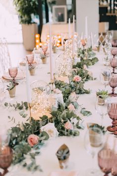 a long table with candles and flowers on it