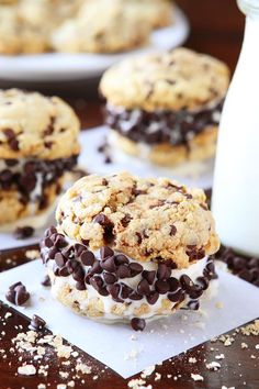 chocolate chip cookies and ice cream sandwiches on paper with milk in the backround