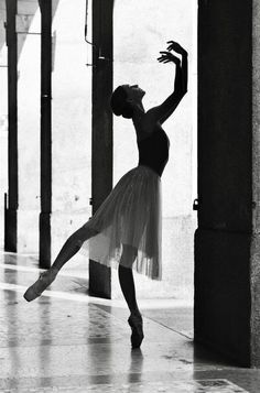 a black and white photo of a ballerina