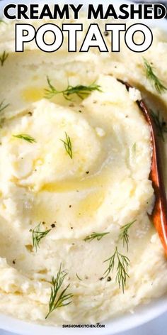 creamy mashed potatoes in a white bowl topped with dill sprinkled on top