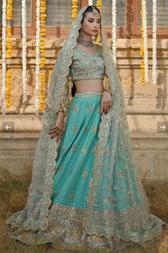 a woman in a blue lehenga and veil