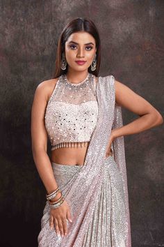 Get set to dazzle at cocktail parties in this beautiful silver sequin georgette pre-draped saree. The saree comes with a stunning designer halter-neck saree blouse. Silk Sarees Kanchipuram, Draped Saree, Latest Designer Sarees, Drape Saree, Fashion Journals, Designer Blouse, Cocktail Parties, Anarkali Suits, Saree Online