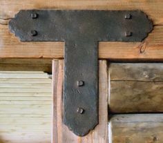 an old wooden cross with metal rivets on it's sides and wood planks