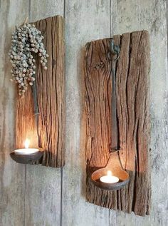 two wooden wall sconces with candles on them