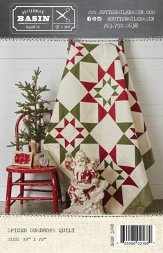 a quilted christmas tree sitting next to a red chair