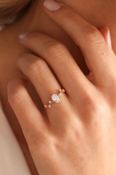 a woman's hand with a diamond ring on it