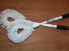 a pair of white brushes sitting on top of a wooden table