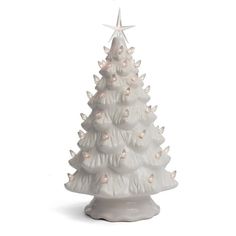 a white ceramic christmas tree with lights