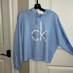 Nwt Calvin Klein Cropped Hoodie Size Is An X-Large. Very Soft Baby Blue With White Ck Lettering Plus “Calvin Klein In Silver Lettering. Very Modern And Classic Oversized Light Blue Hoodie Top, Light Blue Oversized Hoodie, Oversized Light Blue Hoodie, Oversized Light Blue Hoodie For Loungewear, Light Blue Long Sleeve Hooded Top, Light Blue Long Sleeve Top With Drawstring Hood, Calvin Klein Cotton Hoodie With Long Sleeves, Calvin Klein Cotton Hoodie For Fall, Calvin Klein Hoodie Sweatshirt For Fall