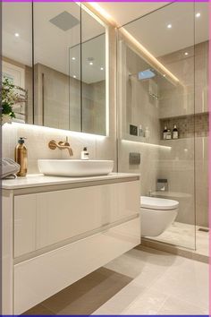 a bathroom with a sink, toilet and shower stall in the background is a large mirror