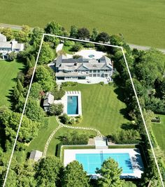 an aerial view of a large house with a swimming pool in the middle of it