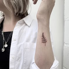 a woman with a small tattoo on her arm