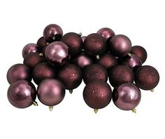 a pile of purple christmas balls sitting on top of each other