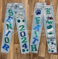 two pairs of jeans with the letters and numbers painted on them