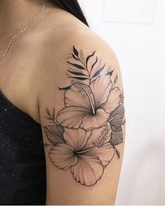 a black and white flower tattoo on the arm