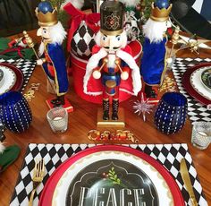 a table set for christmas with plates, silverware and other holiday decorations on it