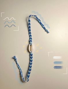 a blue and white rope with a bead on it next to an eraser