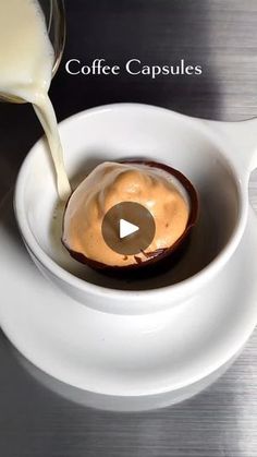 a spoon pouring milk into a bowl filled with food