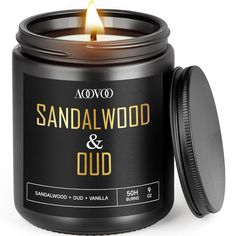 sandalwood and oud candle in a black tin with lid on white background