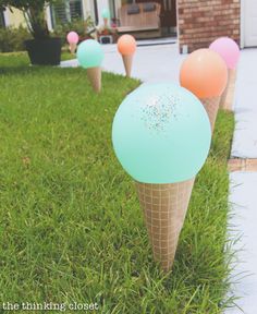 there are ice cream cones with sprinkles on them in the grass outside