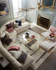 a living room filled with furniture and a fire place in the middle of the room