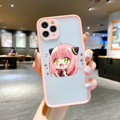 a person holding up a phone case with an anime character on it