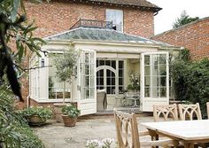 an outdoor dining area with table and chairs