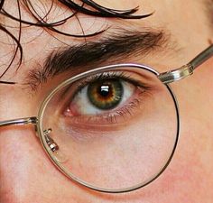 a close up of a person's eye with a magnifying glass in front of them