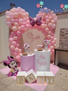 baby shower decorations with minnie mouse and pink balloons on display at the entrance to an event