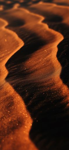 an orange and black photo of the sand