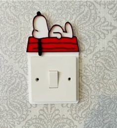 a white light switch with a cartoon character laying on it's side in the wall