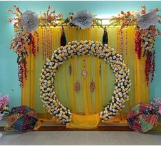 a decorated stage with yellow drapes and flowers