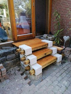 a wooden bench sitting in front of a brick building