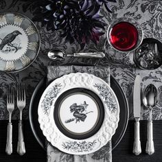 a black and white table setting with silverware